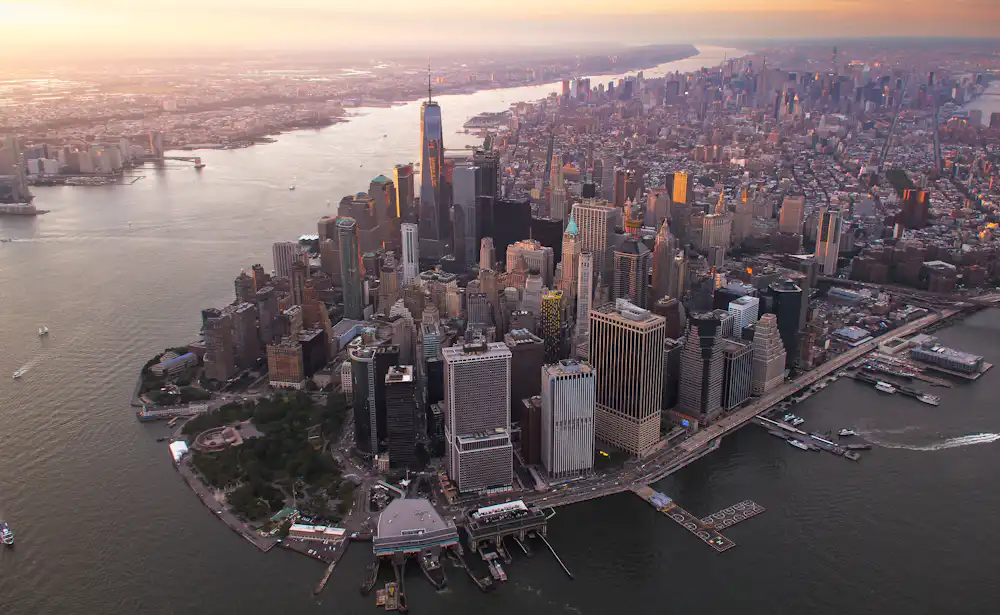 Aerial view of a dense financial district skyline at dusk