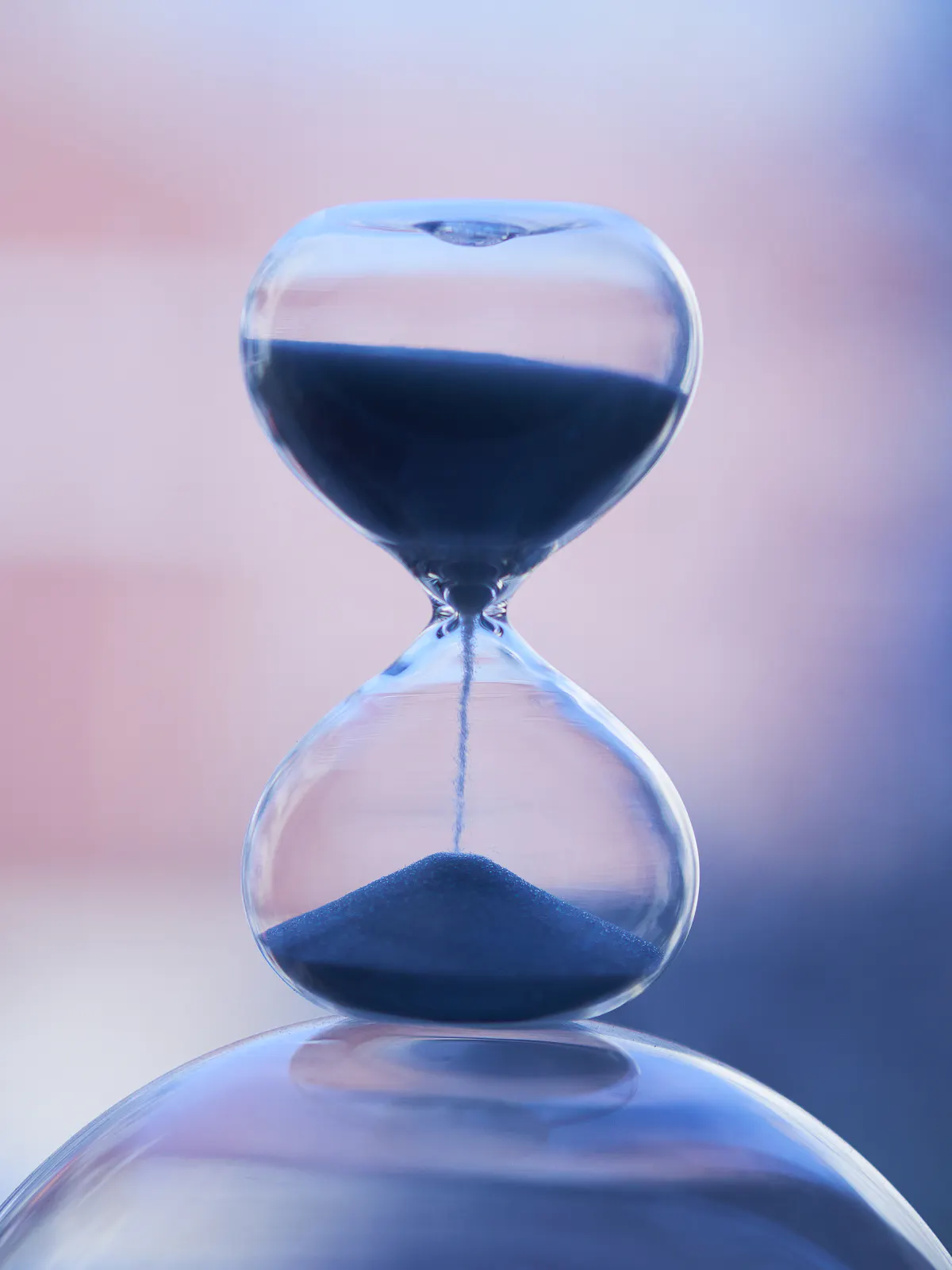 Close-up of an hourglass with sand running through