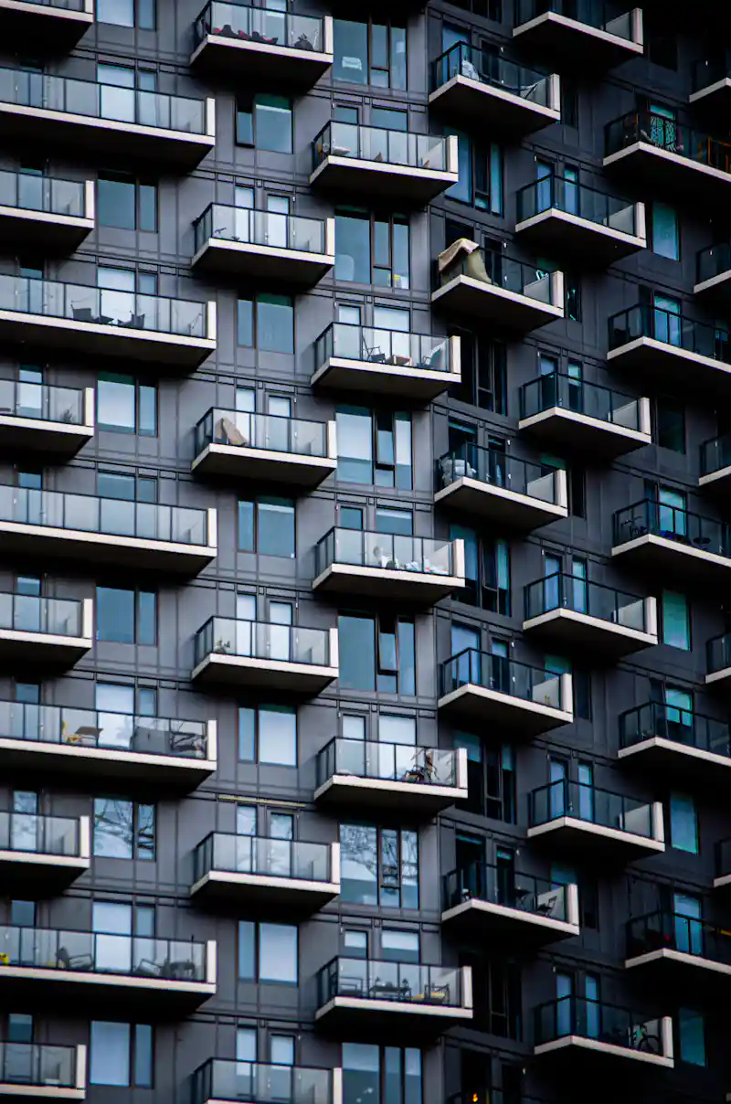 Grid pattern of balconies on a modern high-rise apartment facade