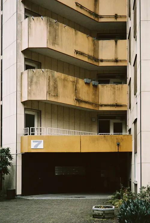 Exterior facade of a multi-unit apartment building with balconies