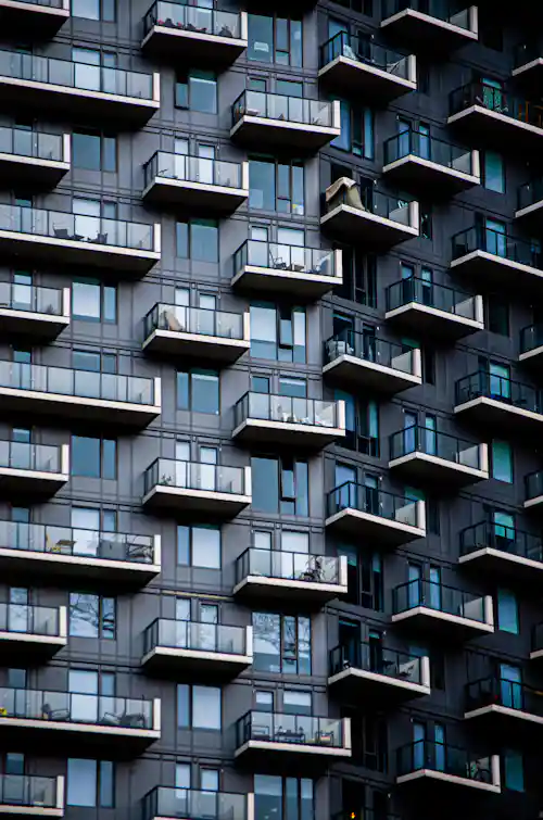 Grid pattern of balconies on a modern high-rise apartment facade