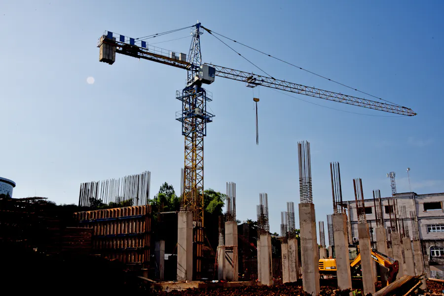 Active construction site with tower crane and structural columns